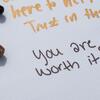 Handwritten notes of encouragement on paper